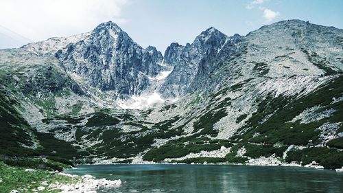 Scenic view of lake and mountains against sky