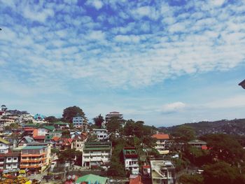 Houses in town against sky