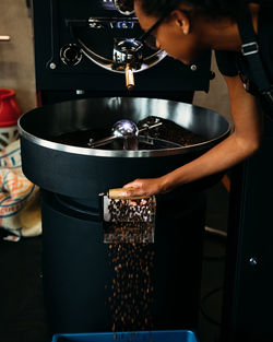 Midsection of man working with coffee