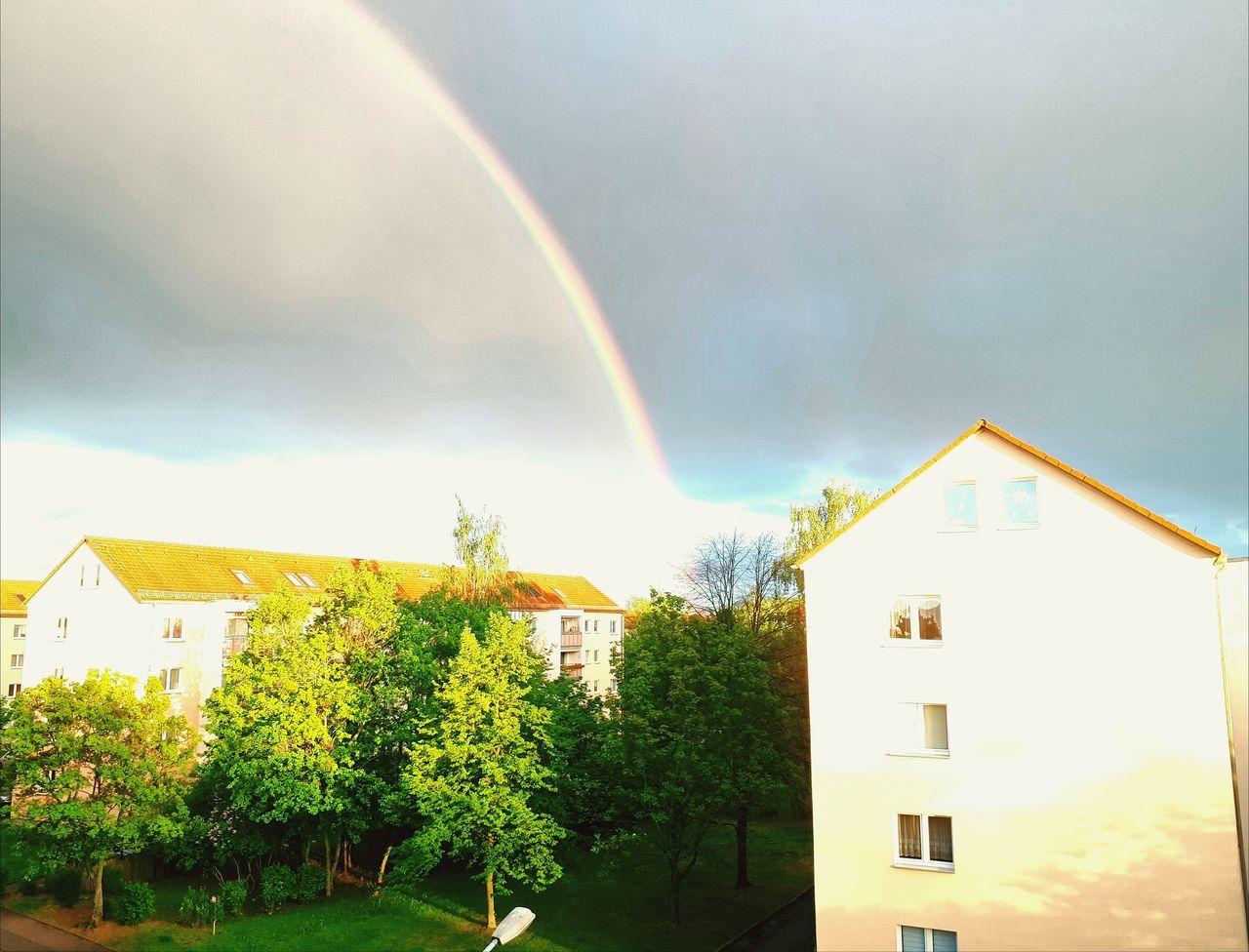 architecture, built structure, building exterior, building, house, rainbow, residential district, sky, nature, plant, cloud - sky, day, no people, tree, outdoors, multi colored, sunlight, city, window