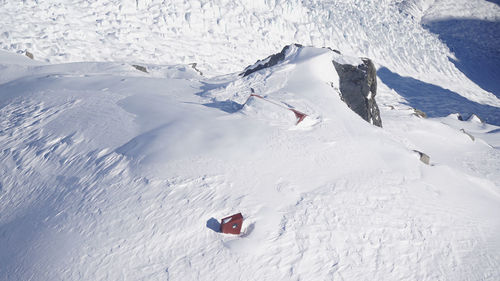 Aerial view of hut on snow covered land