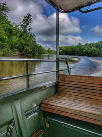 Swimming pool by river against sky