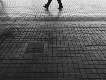 Low section of people standing on tiled floor