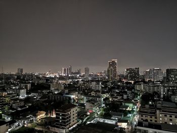 Illuminated cityscape against sky at night