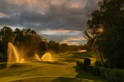 Fountain against sky during sunset