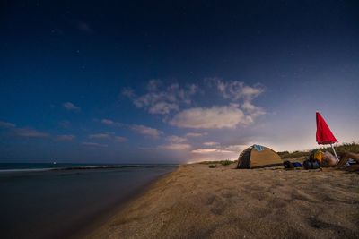 Scenic view of beach against sky at night