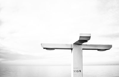 Lifeguard hut in sea against sky