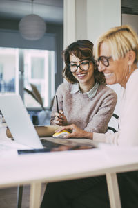 Two businesswomen having fun working together at home