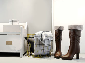 Shoes on table against wall