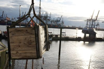 Ship moored at harbor against sky