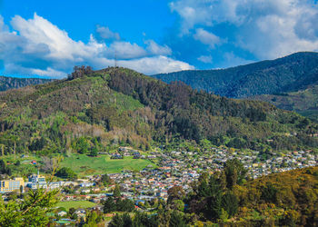 Scenic view of trees and mountains against sky
