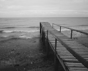 Pier over sea against sky