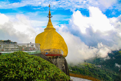 Panoramic view of temple amidst buildings against sky