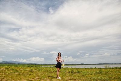 Full length of woman on field against sky