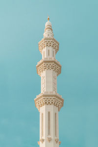 Low angle view of bell tower against blue sky