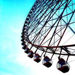 Low angle view of ferris wheel against blue sky