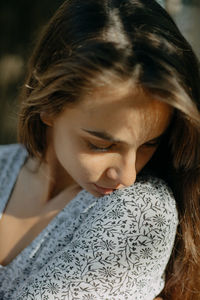 A close up portrait of a worried young woman