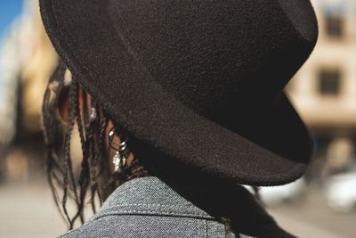 Rear view of person wearing hat standing outdoors