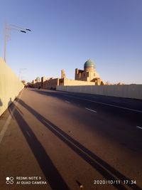 Buildings in city against clear sky