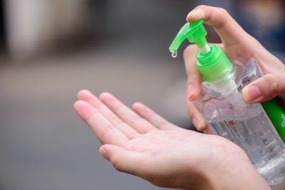 Close-up of person holding bottle in water