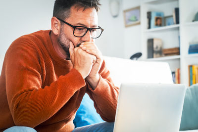 Young man using laptop at home