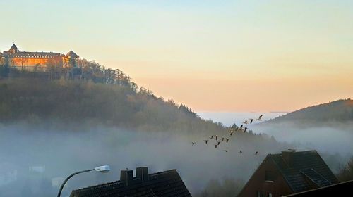 Panoramic view of buildings against sky during sunset