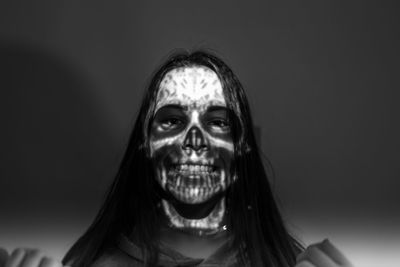 Close-up of spooky woman against black background