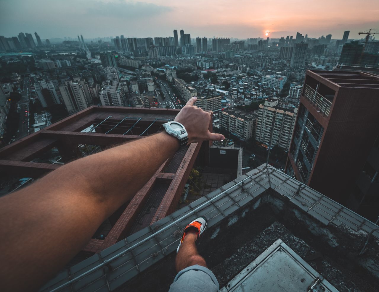 architecture, built structure, city, building exterior, cityscape, real people, one person, sky, hand, human hand, lifestyles, building, high angle view, human body part, men, personal perspective, nature, outdoors, residential district, office building exterior, skyscraper