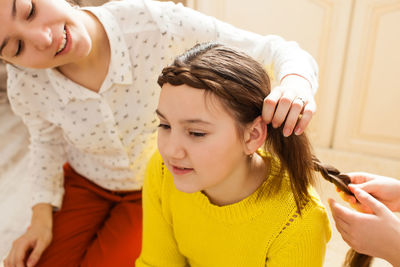 Girl tying hair at home