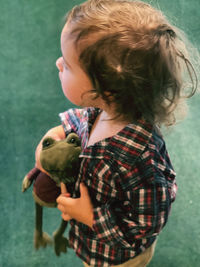 Boy with toy standing outdoors