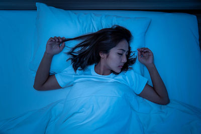 Young woman sleeping in bed