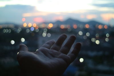 Close-up of person against sky during sunset