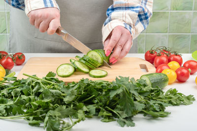 Midsection of man preparing food on table