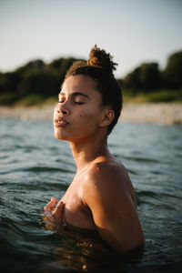 Portrait of shirtless boy in water