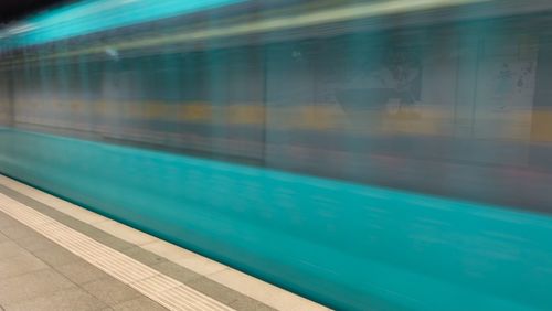 Blurred motion of train at railroad station