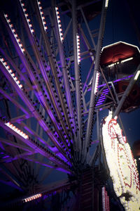 Low angle view of illuminated ferris wheel at night