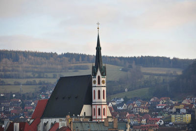 Church against houses in town at dusk