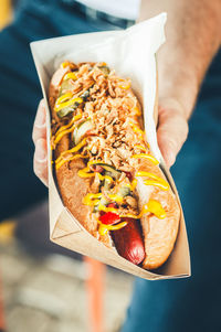 Midsection of man holding food