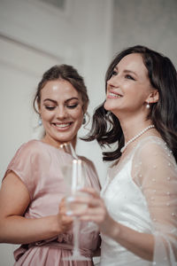 Portrait of a smiling young woman holding hands