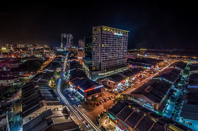 High angle view of illuminated cityscape against sky at night