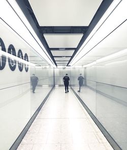 Rear view of man walking in subway