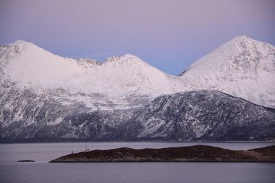 Scenic view of lake and snowcapped mountains against sky