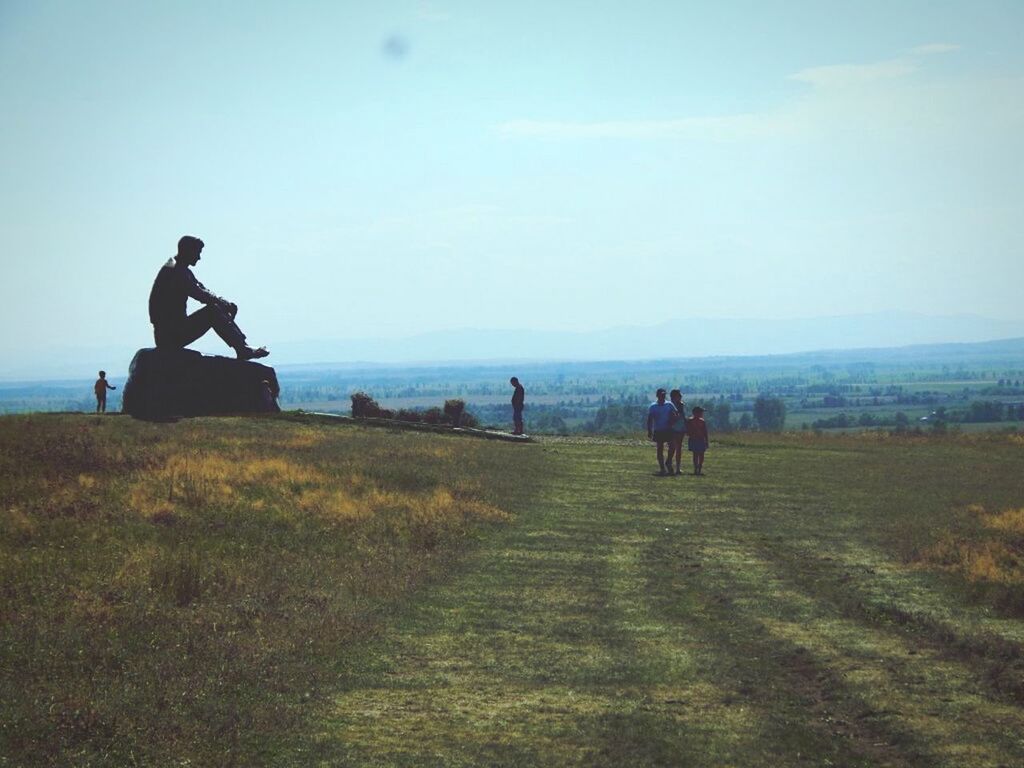 SILHOUETTE OF MAN WITH WOMAN AGAINST CLOUDY SKY