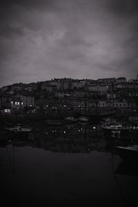River by cityscape against sky