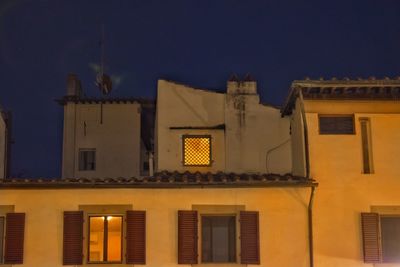 Low angle view of illuminated building against sky at night