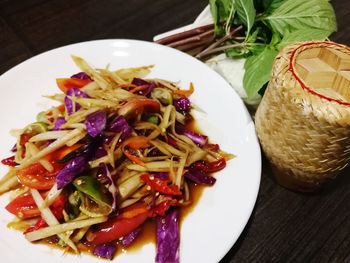 High angle view of chopped fruits in plate on table