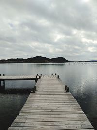 Pier over lake against sky