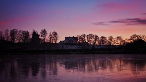 Scenic view of lake at sunset