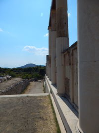 Empty road with buildings in background