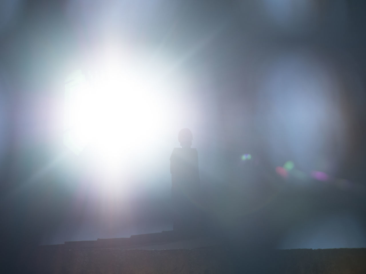 DEFOCUSED IMAGE OF SILHOUETTE PEOPLE IN BRIGHT SUN